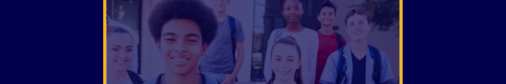 Group of adolescent students smiling outside of a school building